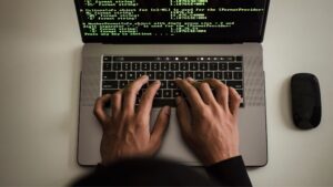 man typing on computer for cybersecurity compliance checklist