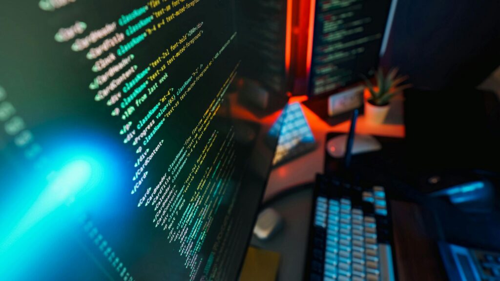 closeup of monitors and keyboard on a desk for an article on what a cybersecurity gap assessment is for small busineses